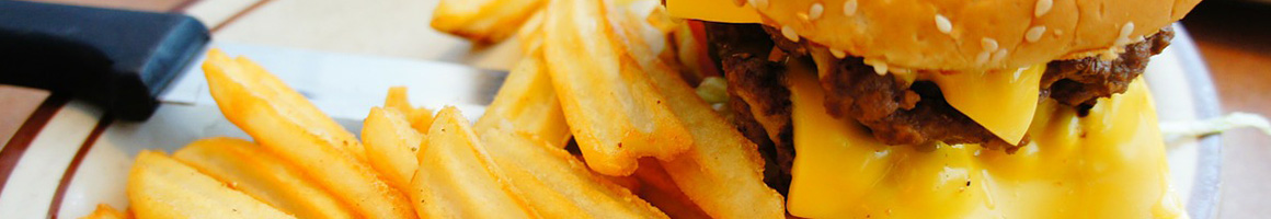 Eating Burger Fast Food at Buzz's Drive Inn restaurant in Goshen, CA.